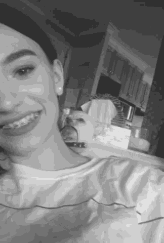 a black and white photo of a woman with braces