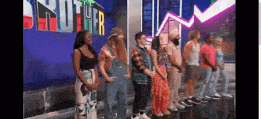 a group of people are standing in front of a sign that says ' brothers ' on it .