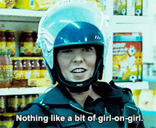 a police officer wearing a helmet says " nothing like a bit of girl-on-girl "