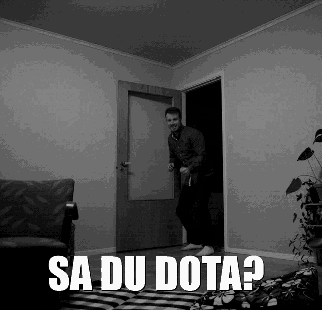 a black and white photo of a man standing in a doorway with the words sa du dota
