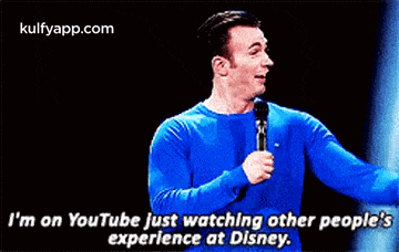 a man in a blue shirt is holding a microphone and says i 'm on youtube just watching other people 's experience