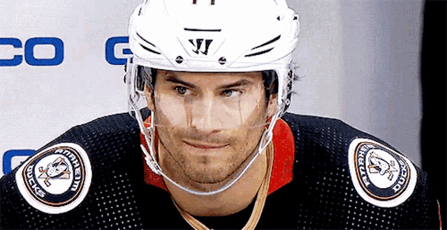 a hockey player wearing a helmet that says warrior on it
