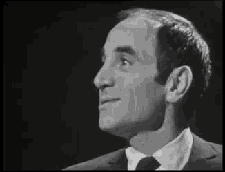 a man in a suit and tie is looking up at the sky .
