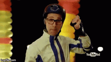 a man wearing a helmet and gloves is standing in front of a youtube red banner