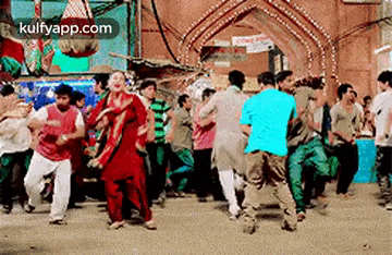 a group of people are dancing in a crowded room .