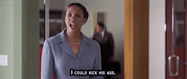 a woman in a suit and necklace says i could kick his ass