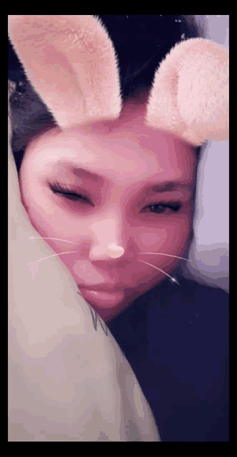 a woman wearing bunny ears and a nose ring