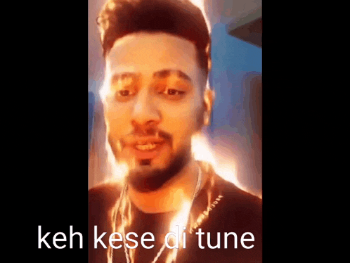 a close up of a man 's face with the words keh kese di tune written on it