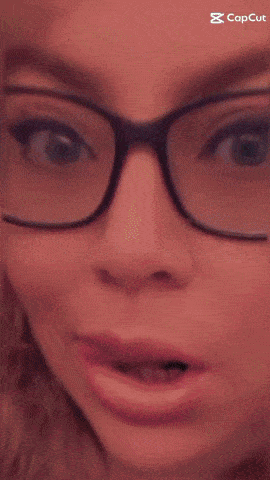 a close up of a woman 's face with a capcut logo in the corner