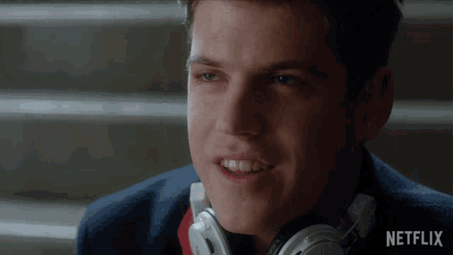 a young man wearing headphones with the word netflix on the bottom right