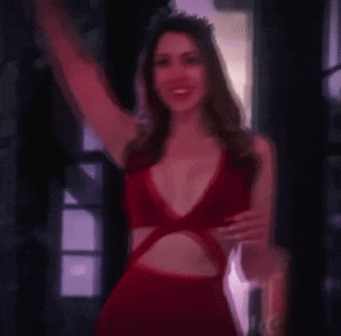 a woman in a red dress with a crown on her head