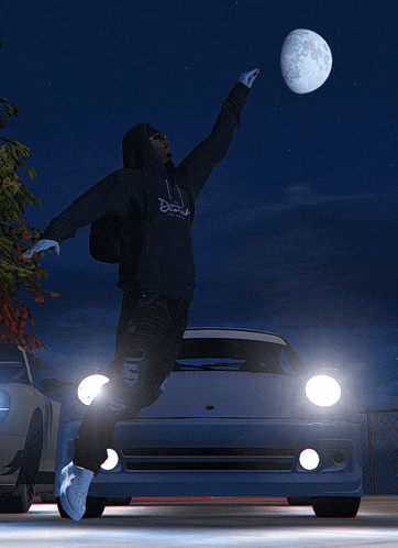 a man wearing a hoodie that says ' dream ' on it is reaching for the moon
