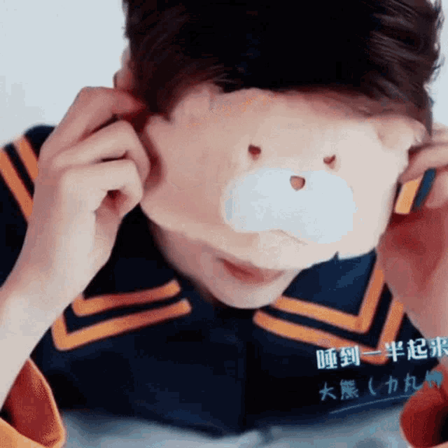a man wearing a teddy bear mask on his face