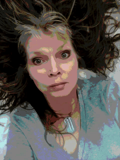 a pixelated image of a woman with a dog tag necklace around her neck