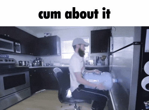 a man sitting in a chair in a kitchen with the words cum about it on the top