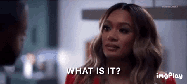 a woman is looking at a man and asking what is it