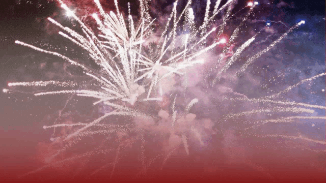 red white and blue fireworks in the sky