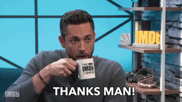a man drinking from a mug that says the imdb show on it