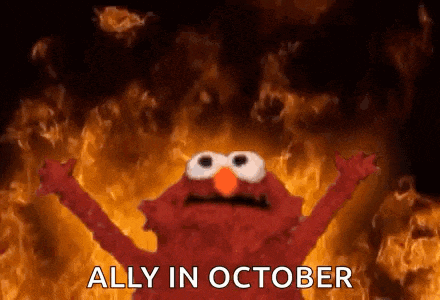 elmo from sesame street is standing in front of a wall of fire .