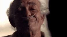 a close up of an elderly man wearing an oxygen mask on his face .