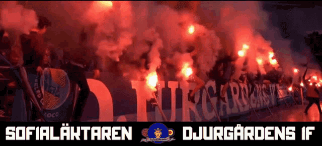 a group of people are holding flares in front of a sign that says djurgardens if