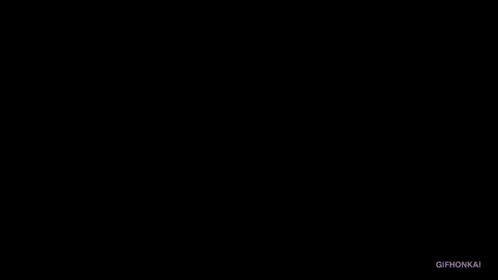 a silhouette of a person in a dark room with a white light coming out of the corner .