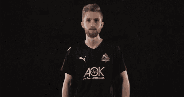 a man wearing a black shirt with aok written on it