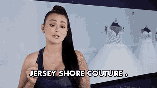 a woman is standing in front of a wall of wedding dresses and saying `` jersey shore couture '' .