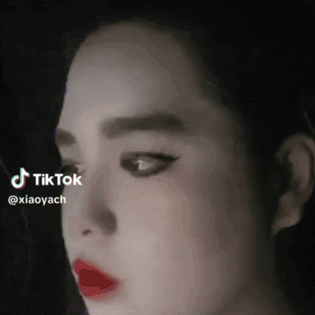 a close up of a woman 's face with a tik tok watermark on it