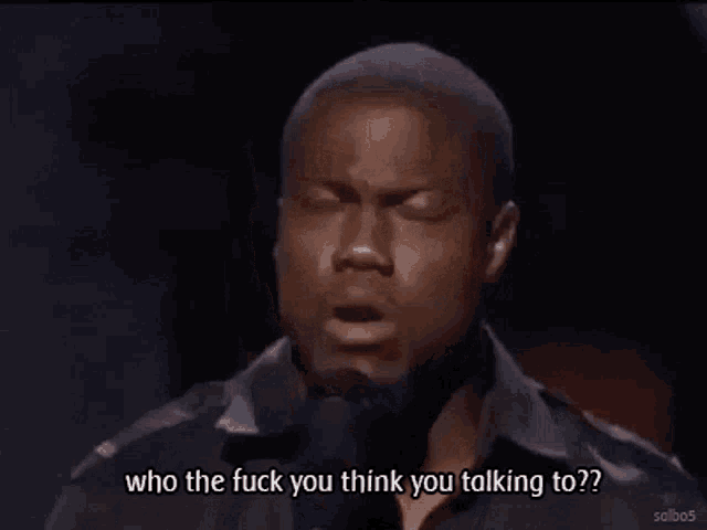 a man singing into a microphone with the words who the fuck you think you talking to