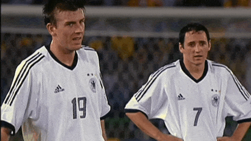two soccer players one wearing number 19 and the other wearing number 7 stand next to each other