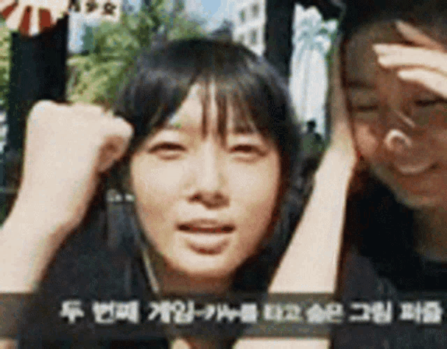 a man and a woman are standing next to each other with their hands on their heads