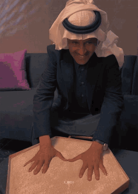 a man 's hands are on a box that says ' x_muzi ' on the bottom