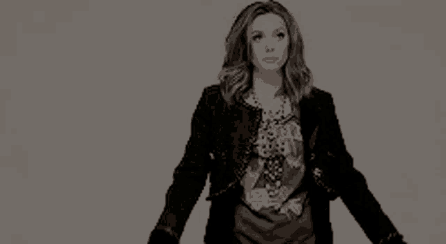 a woman wearing a black jacket and a t-shirt with a picture of a woman on it