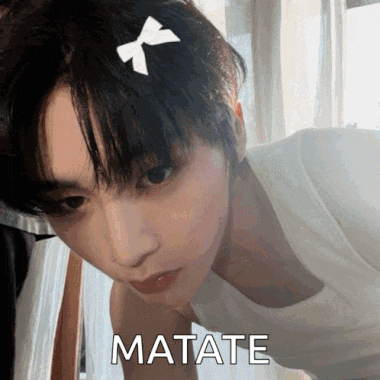 a woman with a bow in her hair has the word matate written on her chest