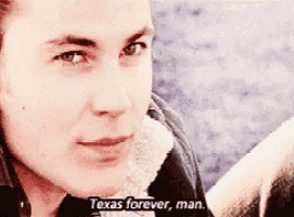 a close up of a man 's face with the words texas forever man on the bottom