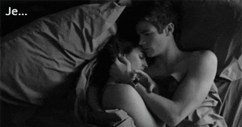 a black and white photo of a man and a woman hugging with the words je written below them