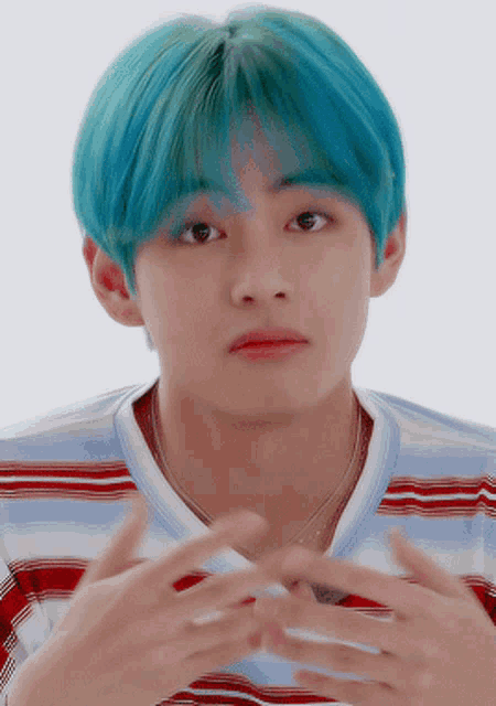 a young man with blue hair wearing a striped shirt
