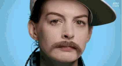 a woman with a hat and a mustache is crying .