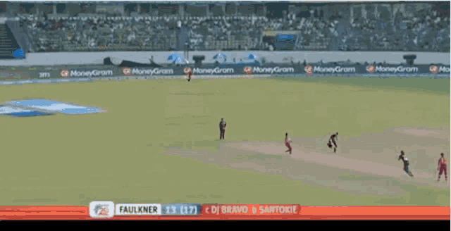 a cricket game is being played in a stadium with moneygram advertisements on the sidelines