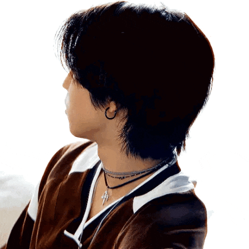 a close up of a person 's neck with a necklace and earrings