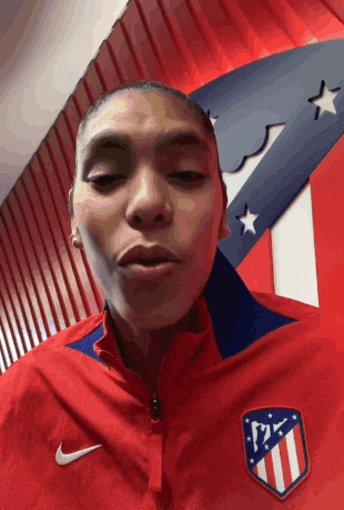 a woman wearing a red jacket with a nike logo on it