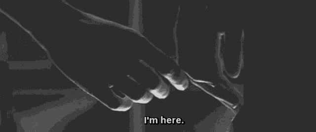 a black and white photo of two people holding hands with the words `` i 'm here '' .