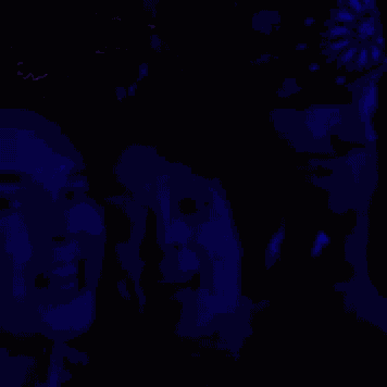 two women are posing for a picture in a dark room with blue lights