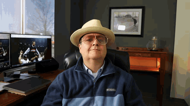 a man wearing a hat and glasses is wearing a columbia fleece jacket
