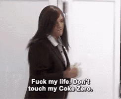 a woman in a suit and tie is saying fuck my life don 't touch my coke zero .