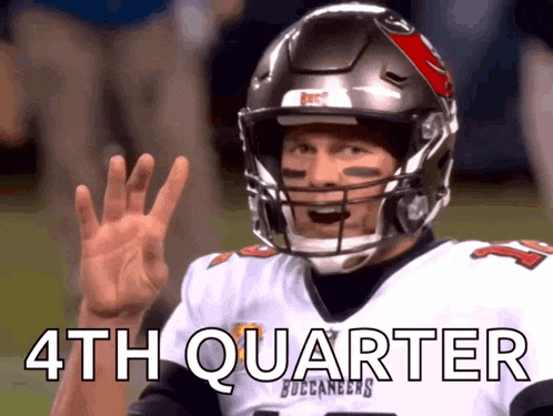 a man wearing a buccaneers jersey and helmet is waving his hand