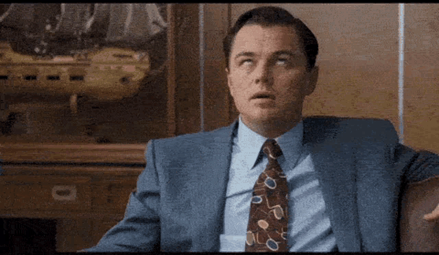 a man in a suit and tie looks up at something