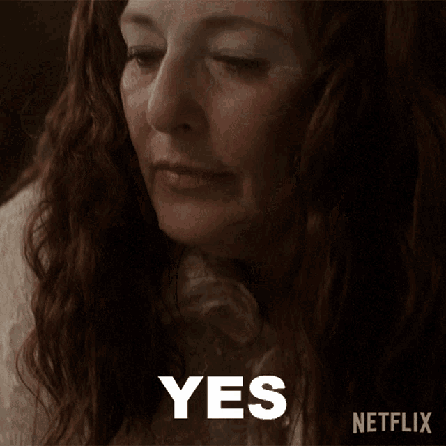 a close up of a woman 's face with the word yes written below her