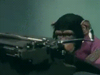 a chimpanzee wearing a pink shirt is playing a piano